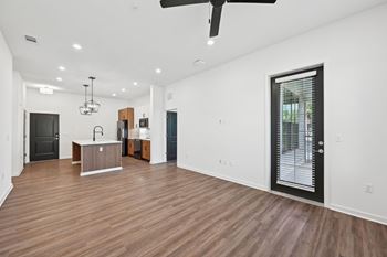 A spacious room with wooden floors and a ceiling fan. at The Concord Luxury Apartments, Sarasota, FL, 34240